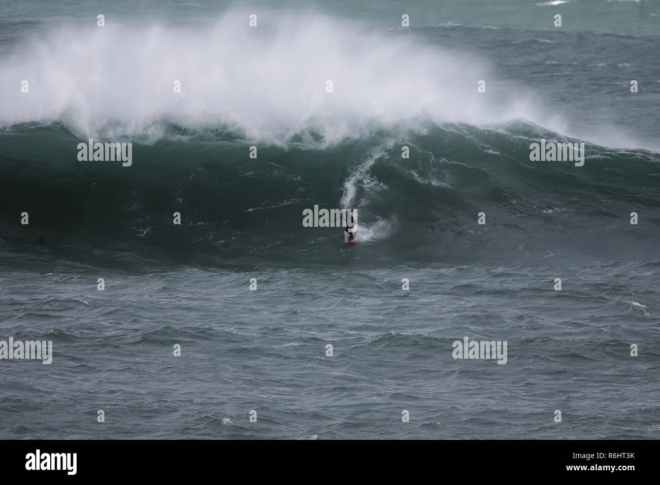Big wave surfing at Newquay`s Cribbar point at Fistral Bay, Cornwall, UK Stock Photo